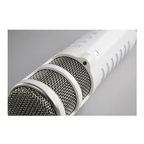 Close-up of a white microphone with metallic grille